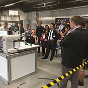 Conference excursion to ZfT showing advanced satellite production supported by robots, applying force feedback for integration